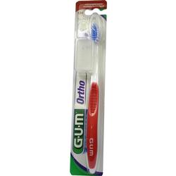 Eine Zahnbürste mit rotem Griff in einer Plastikverpackung.